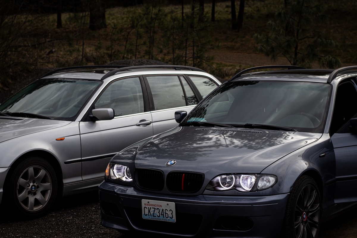 BMW E46 front and profile view with trees reflecting on hood