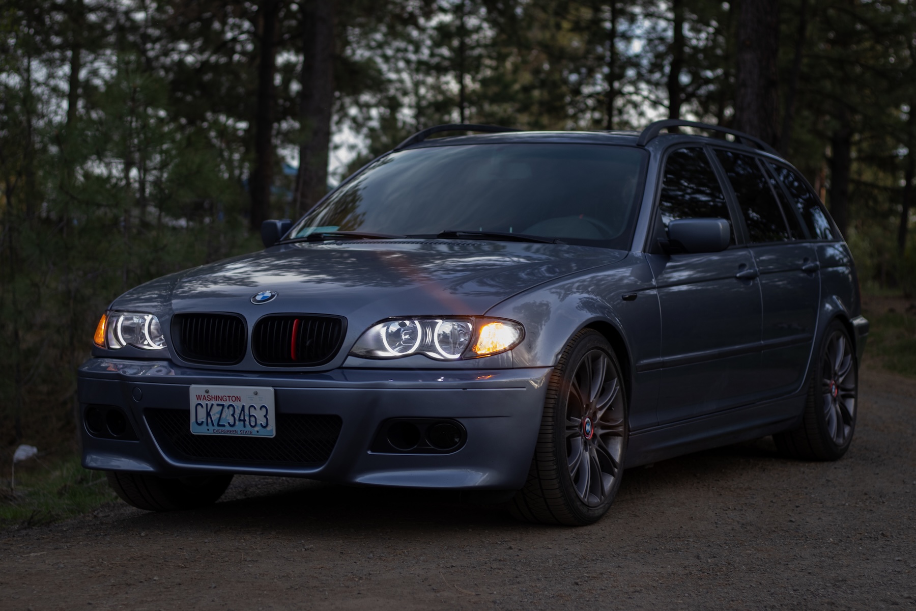 BMW E46 parked at dusk with headlights off