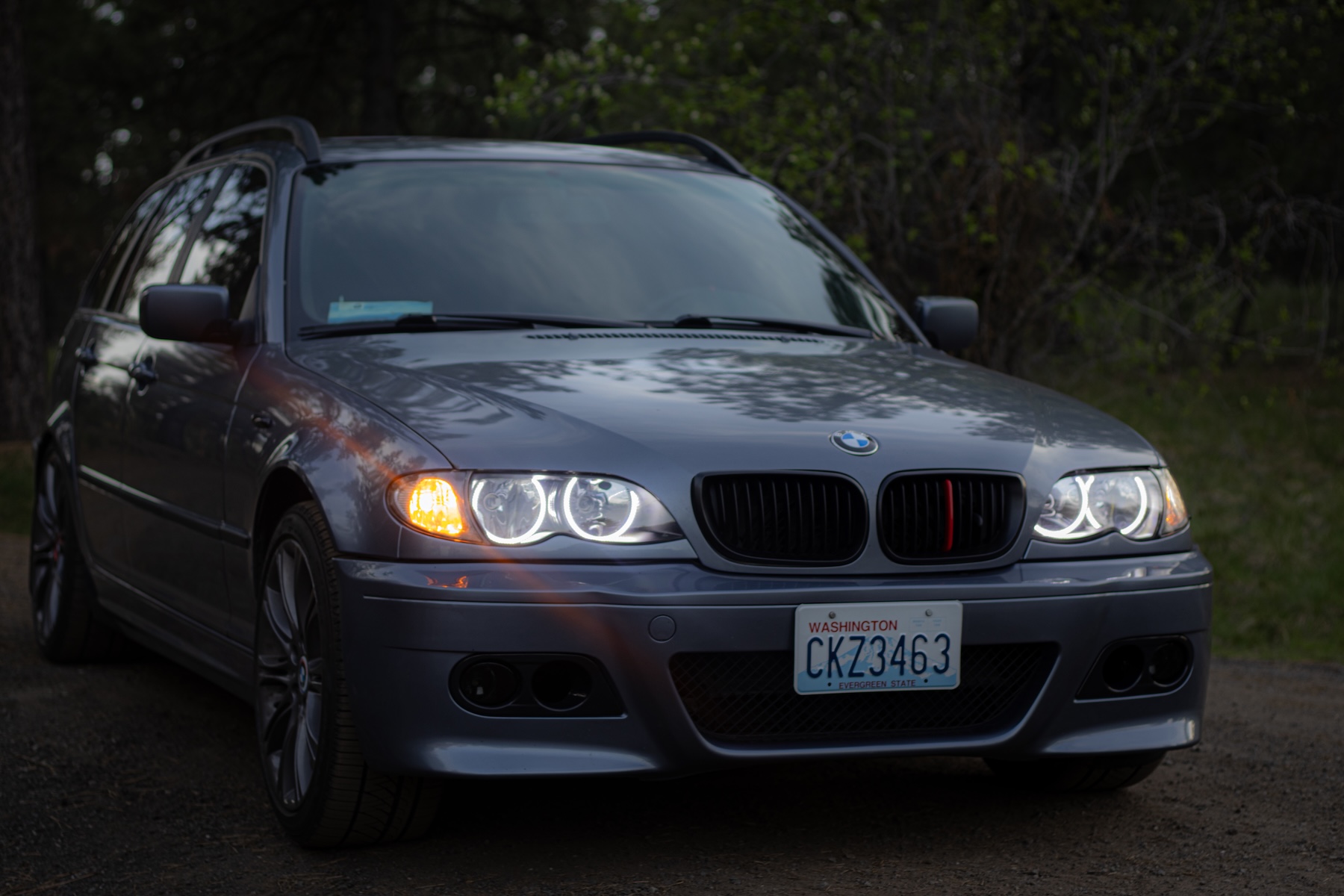BMW E46 with headlights on during twilight