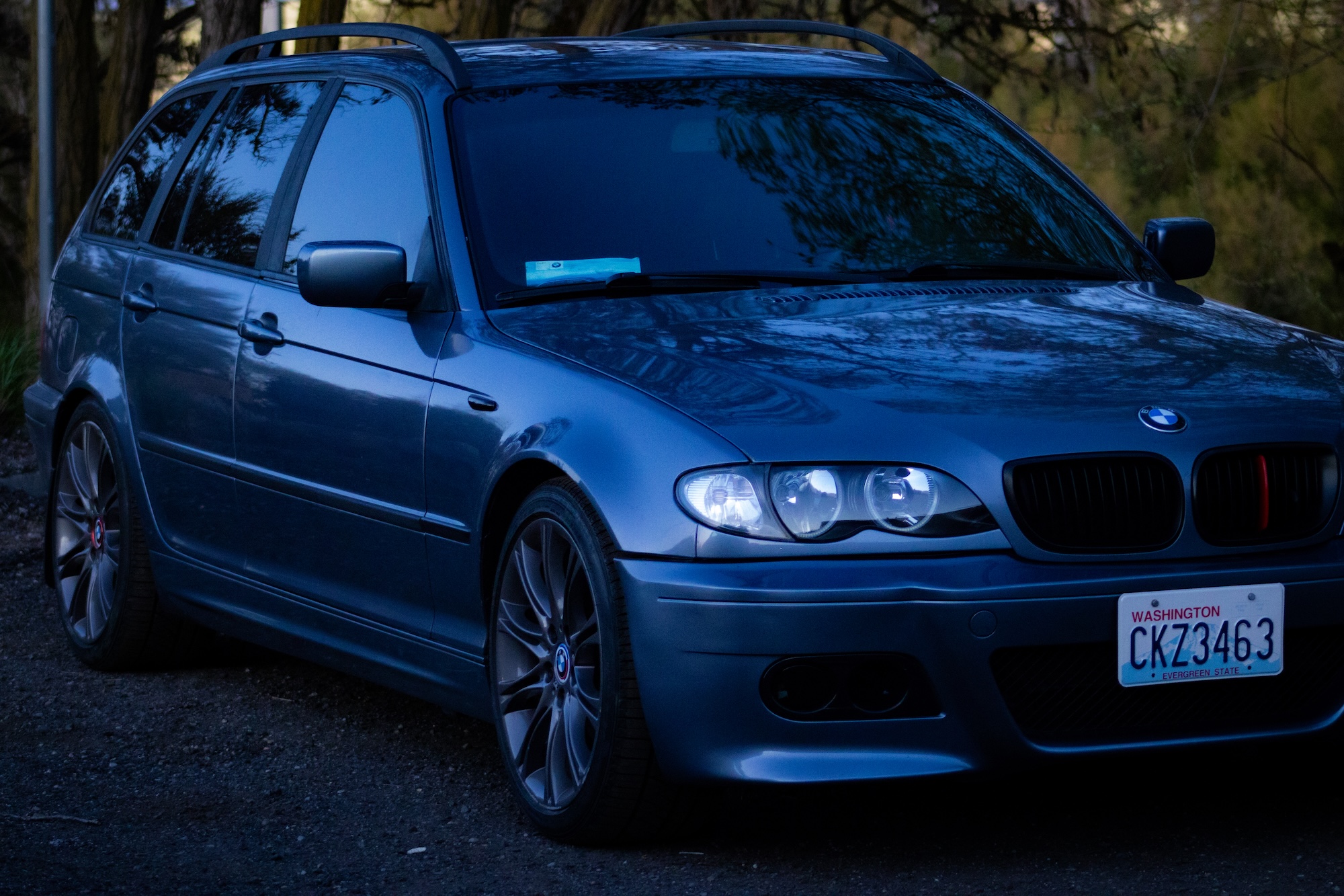 BMW E46 parked next to garden rock feature