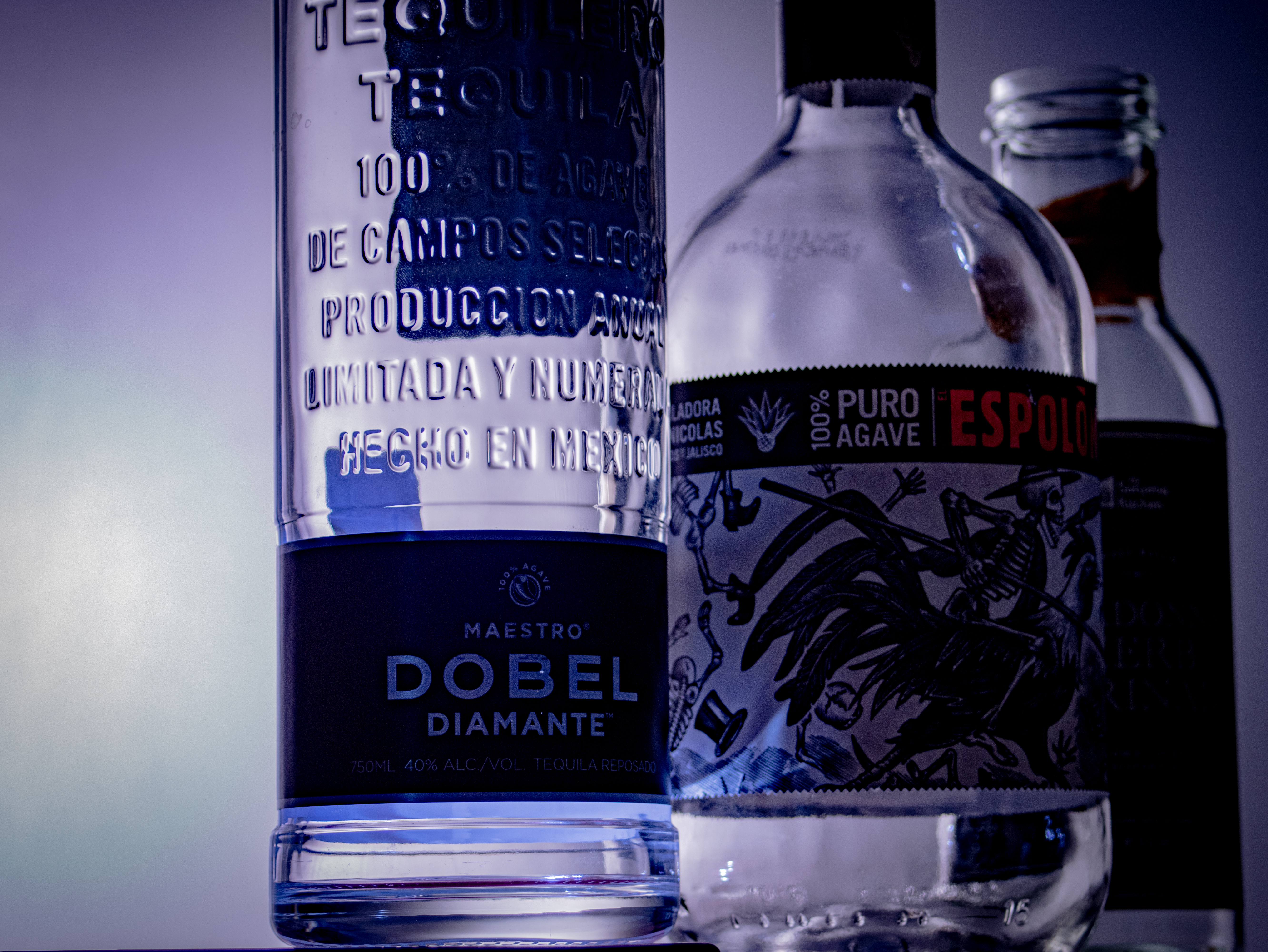 Cool toned overhead lighting on bottles